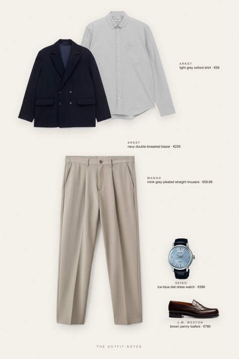 Flat-lay of the pieces in this outfit: navy double-breasted blazer, light grey oxford shirt, mink-grey pleated straight trousers, brown penny loafers, ice-blue dial dress watch.